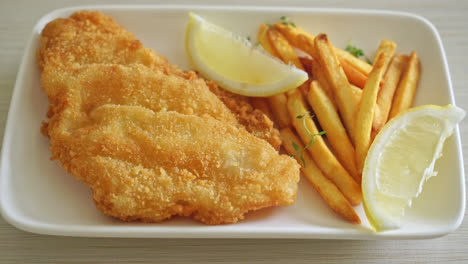 fish-and-chips---fried-fish-fillet-with-potatoes-chips-and-lemon-on-white-plate