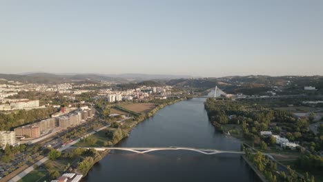 River-Mondego-and-Rainha-Santa-Isabel-bridge-in-background,-Coimbra-in-Portugal