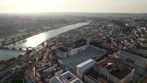 Aerial-forward-over-Coimbra-University-and-Mondego-river-in-background,-Portugal