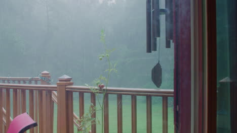 Rain-On-Porch-With-Windchimes-and-Tomato-Plant