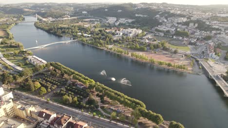 Panoramic-aerial-view-of-Mondego-river-and-reveal-of-Coimbra-University-buildings