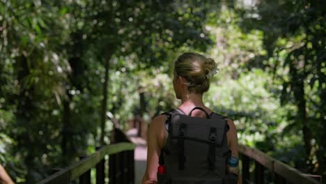 Behind-female-backpacker-walking-through-wonderful-lush-jungle-of-Cahuita-National-park