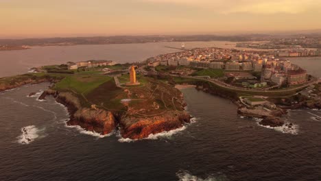 Aerial-view-at-sunset-of-the-la-coruna-cityscape-harbor-old-Roman-lighthouse-and-urban-area