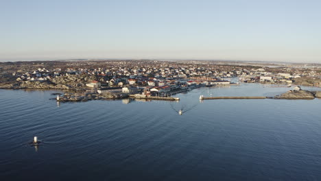 Drone-wide-shot-of-a-harbor-port-at-Öckerö-Island-Municipality-in-Gothenburg-archipelago,-Sweden