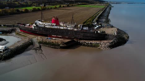 Aerial-View-of-TSS-Duke-of-Lancaster-currently-beached-near-Mostyn-Docks,-North-Wales---drone-shot