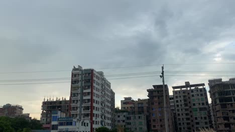 Dhaka-residential-buildings,-sideways-dolly-left-shot,-cloudy-sunset,-Bangladesh
