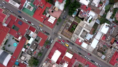 Aerial-view-of-Oaxaca's-city-center-filmed-by-a-drone-with-top-down-displacement,-showing-car-traffic-at-a-crossing