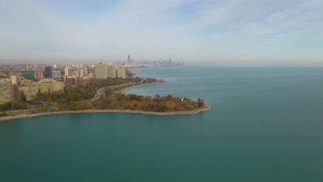Chicago-Skyline-in-the-Distance,-High-Aerial-View-from-South-Side-Above-Lake-Michigan