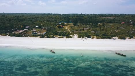 Smooth-aerial-flight-fly-forwards-drone-shot-over-nice-crystal-clear-turquoise-water-reef-to-a
Paradise-white-sand-dream-beach-Zanzibar,-Africa-2019