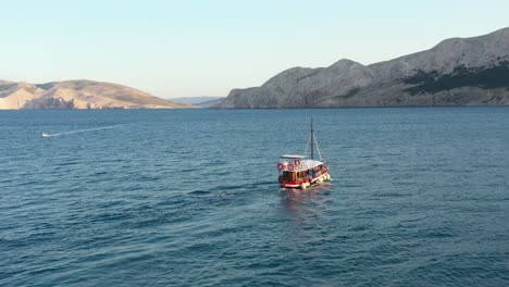 Boat-Sailing-On-Adriatic-Coast-Towards-The-Krk-Island-In-Croatia