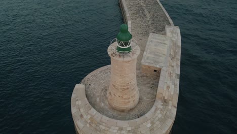 Close-aerial-view-flying-around-a-stone-light-house,-St