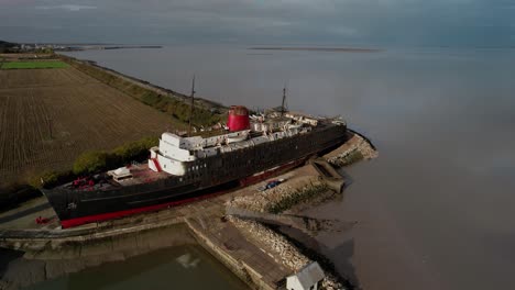 Push-in-aerial-shot-over-the-TSS-Duke-of-Lancaster-aka-The-Fun-Ship-in-North-Wales-near-Moyston-Docks