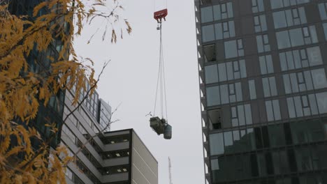 Construction-Crane-Hook-Block-And-Cable-Lifting-Piles-Of-Debris-At-The-Building-Site