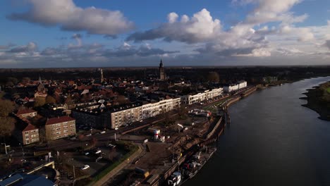 Countenance-riverside-aerial-view-with-renovation-of-IJsselkade-boulevard-quay-heavy-equipment-working-on-quay-in-the-foreground-and-wider-historic-cityscape-of-Zutphen-seen-from-above-river-IJssel