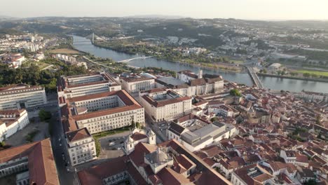 Aerial-orbiting-around-Coimbra-University-and-Mondego-river-in-background,-Portugal