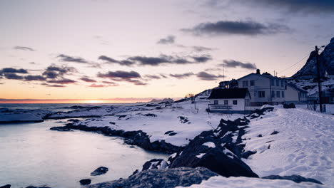 Time-Lapse-of-a-calm-sea-during-sunset-behind-a-house-on-a-Lofoten-coast-in-winter