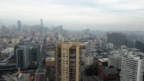 Aerial-view-revealing-the-Tenderloin-district-in-cloudy-San-Francisco---rising,-tilt,-drone-shot