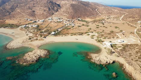 aerial-drone-view-of-village-magganari-bay-beach-in-ios-island