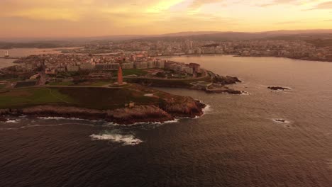 Aerial-footage-la-coruna-cityscape-view-at-sunset,-drone-fly-above-the-city-in-Galicia-region-north-Spain-coastline-over-the-Atlantic-sea,-tourist-Spanish-travel-destination