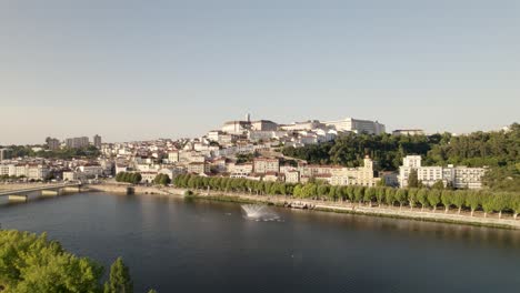 Aerial-forward-ascendent-over-Mondego-river-at-Coimbra,-Portugal