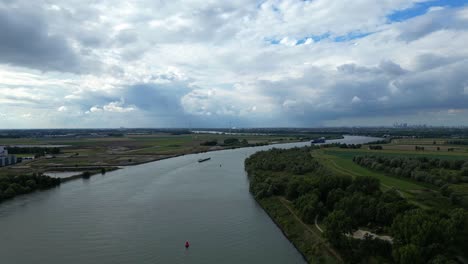 View-of-Schelda-river-in-Zwijndrecht,-Belgium-with-cargo-ship-sailing