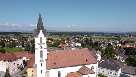 Drone-flies-by-a-church-in-Austria---blue-sky-and-sunny-weather---Steinakirchen-am-Forst
