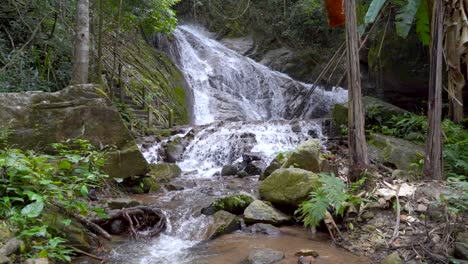 Cascades-of-waterfall,-falling-down-in-slow-motion-in-jungle