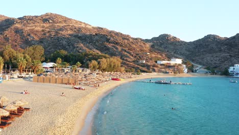 Aerial-Drone-View-Mylopotas-Beach-in-Ios-Island-Greece-during-Sunset-Dusk