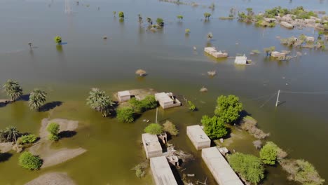Aerial-View-Of-Floods-Surrounded-Rural-Buildings-In-Jacobabad,-Sindh