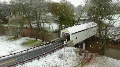 Snow-flurries-at-white-covered-bridge-in-rural-USA