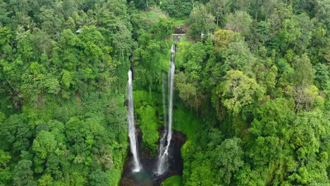 aerial-top-down-of-twin-waterfalls-in-dense-jungle-of-Bali-Indonesia