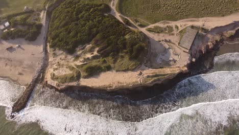 Aerial-top-down-forward-over-cliffs,-Acantilados-in-Argentine