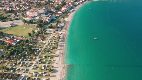 Flyover-shot-of-the-coastline-of-a-city-on-Krk-Island,-Croatia