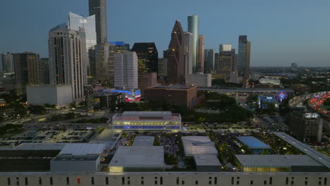 Aerial-view-of-downtown-Houston-city,-dusk-in-Texas,-USA---tracking,-drone-shot