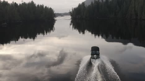 A-power-boat-driving-on-glassy-water-on-Vancouver-Island,-British-Columbia