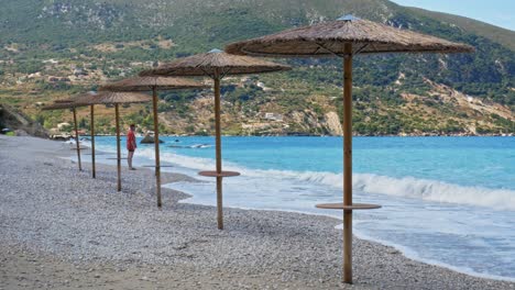 Man-Standing-By-The-Shore-Of-The-Idyllic-And-Quiet-Agia-Kyriaki-Beach-In-Kefalonia-Greece---wide-shot