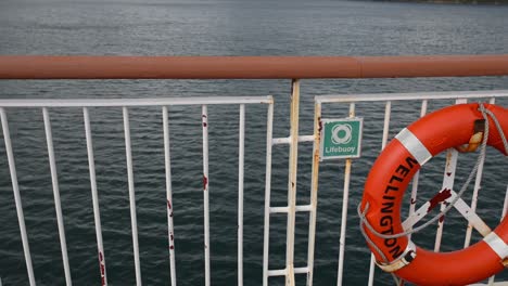 Lifebuoy-on-a-moving-ship's-side-railing-with-the-word-'Wellington'-written-on-it