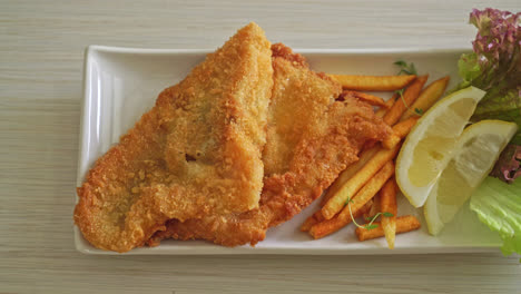 fish-and-chips---fried-fish-fillet-with-potatoes-chips-and-lemon-on-white-plate