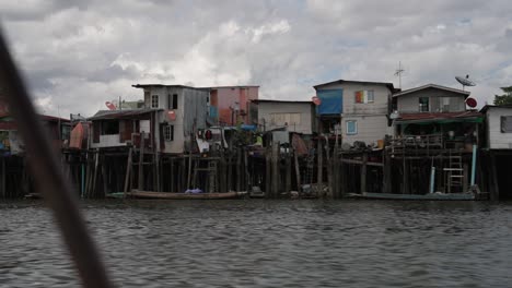 Poor-Housing-and-Living-Conditions-along-the-River,-Illegal-Settlements,-Asian-City-Slum