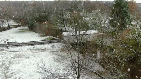 Aerial-of-white-covered-bridge-reveal-in-winter-snow