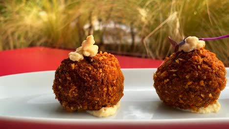 Traditional-Spanish-croquettes,-tasty-and-crispy-breaded-starter-dish-in-a-restaurant,-4K-shot