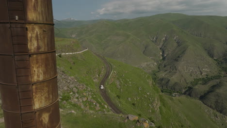 Secluded-eurasian-landscape-with-a-winding-road-and-mysterious-rusted-tower