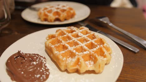 Close-up-of-tasty-Swedish-waffles-and-chocolate-in-traditional-restaurant
