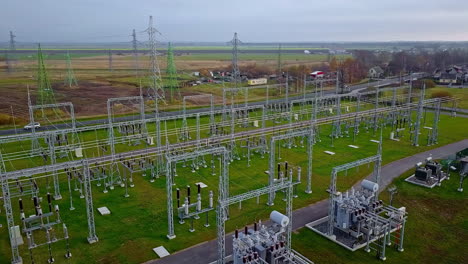drone-flight-over-a-power-plant-with-all-departing-high-voltage-cables-on-high-poles