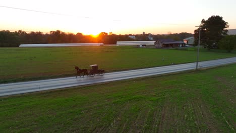 Amish-Mennonite-horse-and-buggy-on-rural-country-ride-at-sunset