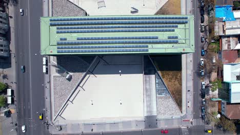 Overhead-aerial-view-of-the-design-of-the-Museo-de-la-Memoria-with-solar-panels-on-the-roof,-sunny-day,-Santiago,-Chile