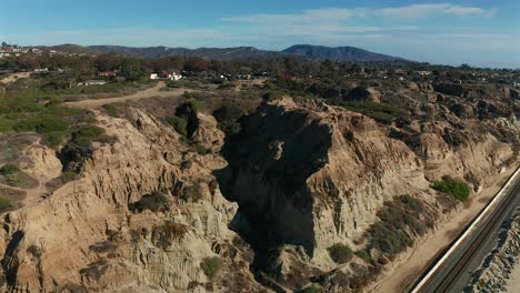 Rising-aerial-view-of-San-Clemente-State-Park-and-the-jagged-cliffs-in-Southern-California