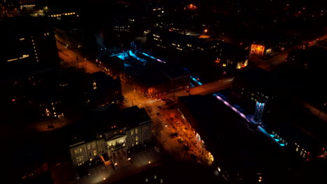 Aerial-View-Of-Cars-Driving-In-The-Street-Of-Sherbrooke-City-Illuminated-With-Lights-During-Nighttime---drone-pullback