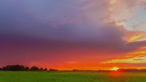 Colorful-Sunset-Sky-Over-Green-Fields-On-The-Countryside
