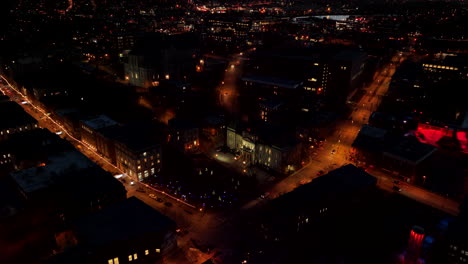 City-Of-Sherbrooke-Illuminated-With-Lights-During-Nighttime-In-Canada---aerial-pullback